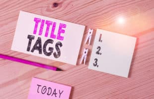 Conceptual hand writing showing Title Tags. Business photo text the HTML element that specifies the title of a web page Colored crumpled papers wooden floor background clothespin.