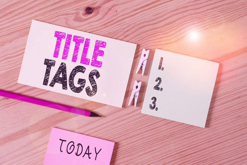 Conceptual hand writing showing Title Tags. Business photo text the HTML element that specifies the title of a web page Colored crumpled papers wooden floor background clothespin.