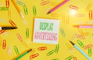 Handwriting text writing Display Advertising. Concept meaning online advertising that is typically a designed image Flat lay above empty paper with copy space pencils and colored paper clips.