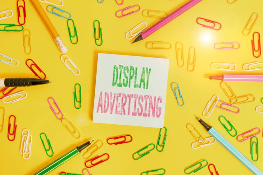 Handwriting text writing Display Advertising. Concept meaning online advertising that is typically a designed image Flat lay above empty paper with copy space pencils and colored paper clips.